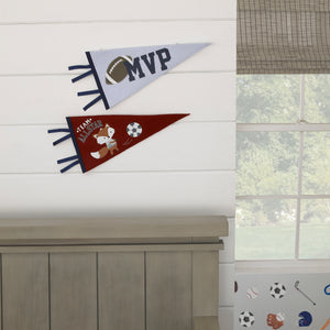 Two sport-themed felt pennants hanging on a wall, one with a fox design in grey, burgundy, and navy, and the other with a football and MVP text in light blue and navy.